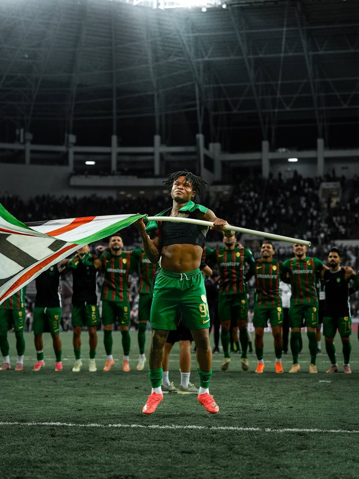 Gift Orban waving a flag in front of his team after a win